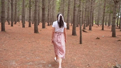 Young woman walking through empty woods Stock Footage 220759922