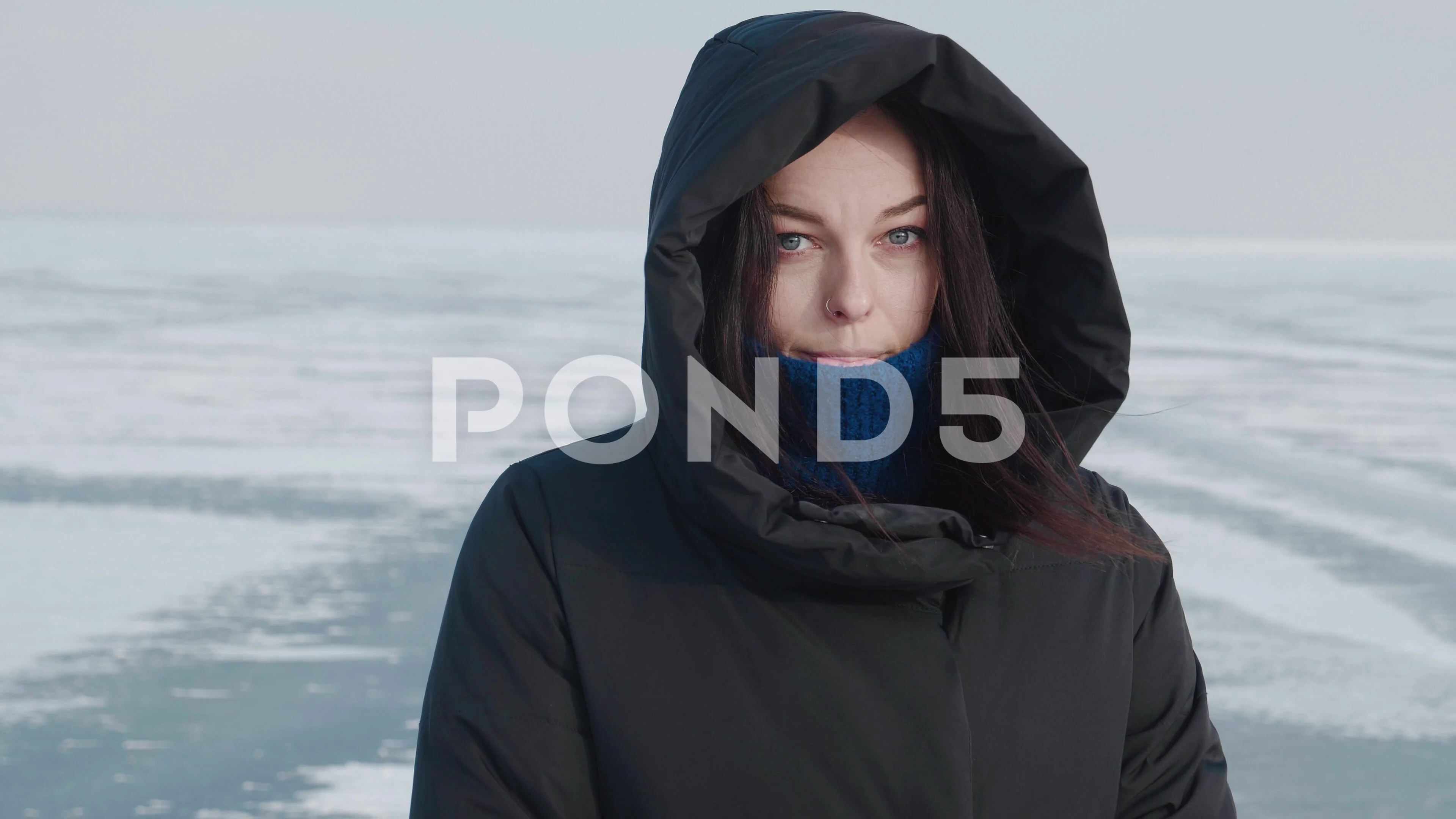 Young woman in warm down jacket with a h, Stock Video
