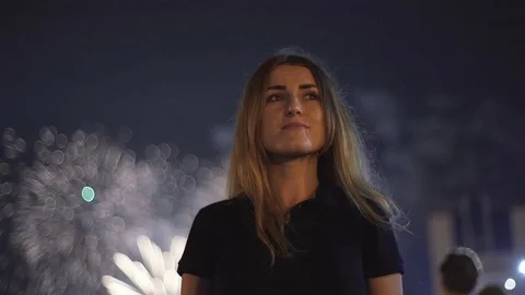 Young woman watching the beautiful holiday fireworks. slow motion Stock Footage