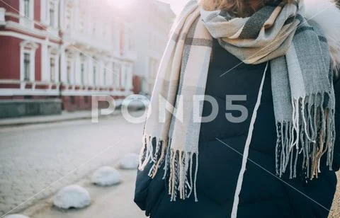 Young woman wearing big wool scarf in city Stock Photos