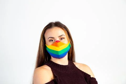 Young woman wearing gay pride rainbow mask Stock Photos