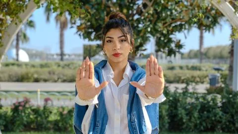 A young woman  while making a "stop" gesture with her hands Stock Photos