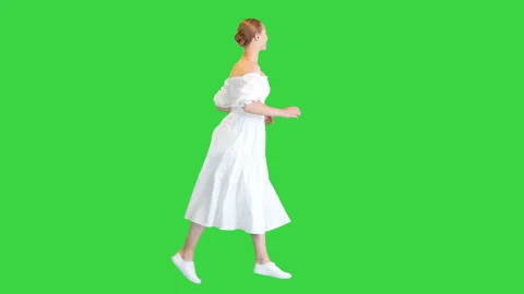 Young woman in white dress running on a Green Screen, Chroma Key. Stock Footage