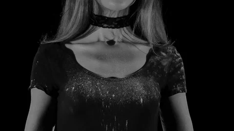 Young woman in a white empty cloud of flour in a black background. Stock-Footage 81473625
