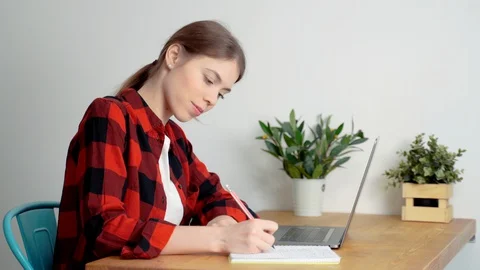 A young woman who can be a young entrepreneur or a student or a writer is wor Stock Footage