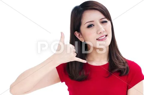 Young woman winking and making call me gesture Stock Photos