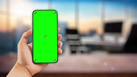 Young woman in work office using smartphone with green mock up screen chroma key Stock Footage 306171843