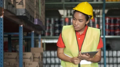 Young woman worker using tablet for check inventory in warehouse. Stock Footage 143956865