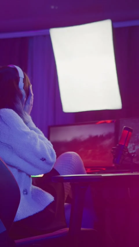 Young Woman Working At Computer Desk With Headphones And Dual Monitors In Stock Footage 345977500