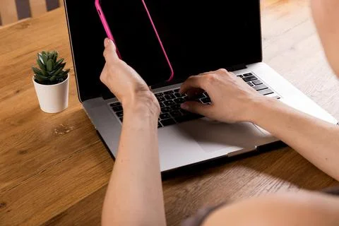 Young woman working on computer at table in office, closeup. Banner design Stock Photos
