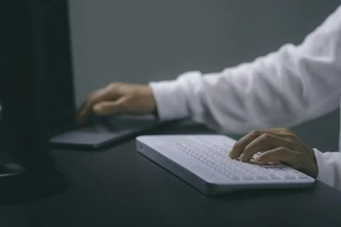 Young woman working in front of the computer on the desk Stock Photos
