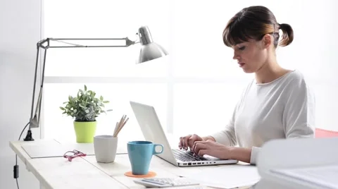 Young woman working with a laptop Stock Footage