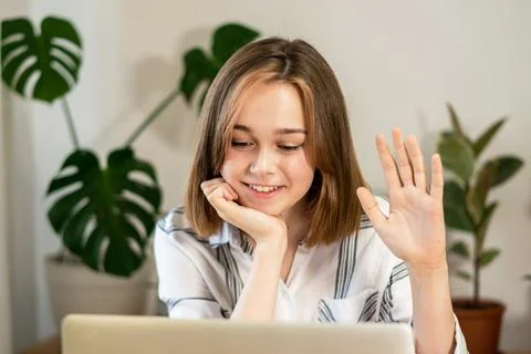 Young woman working on laptop at home. Stock Photos