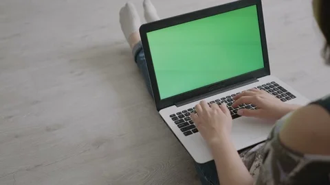 Young woman working on laptop while sitting on floor Stock Footage 80697014