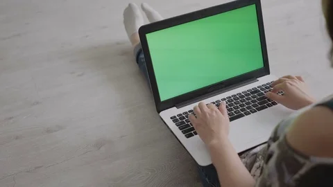 Young woman working on laptop while sitting on floor Stock Footage 80847513