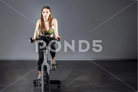 Premium Photo  Young woman working out in gym using gym equipment