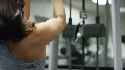 Young woman working out lifting weights on a machine in the gym Stock Footage 59742277