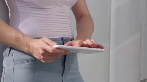 Young woman working on tablet computer, outdoor in the sunny city Stock Footage 72348208