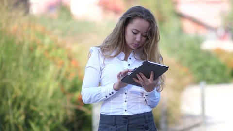Young woman working with tablet pc outdoor 스톡 동영상 84024497