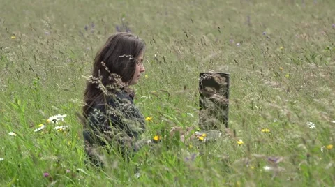 Young woman working at tablet in spring nature  Stock Footage 46207420