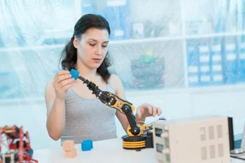 Young   woman working using a robotic arm Stock-Fotos