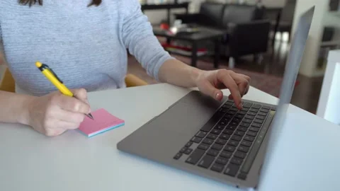 Young Woman Write Important Notes On Stickers At Table In Office Stock Footage 148126702