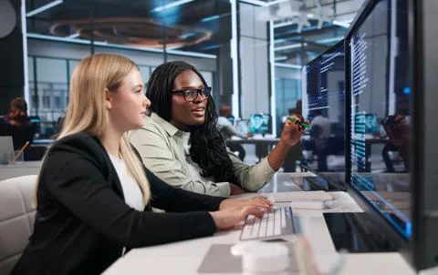 Young Woman Writer Types Code On Laptop In Bright Office Room Stock Photos