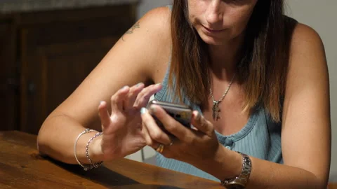 Young woman writes a message using in cellphone at home Stock Footage 138619925