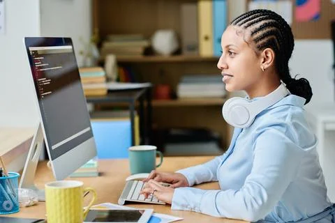 Young woman writing codes for program on computer Stock Photos