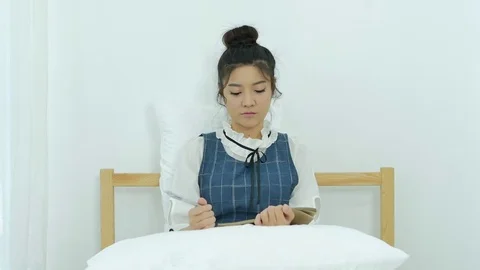 Young woman writing diary while sitting on the bed in her room Stock-Footage 81453940