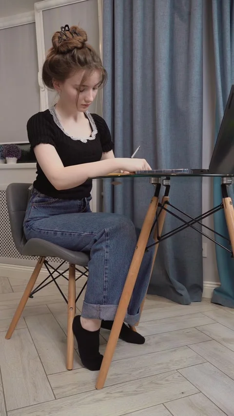 Young woman writing notes while studying at home Stock Footage 311780138