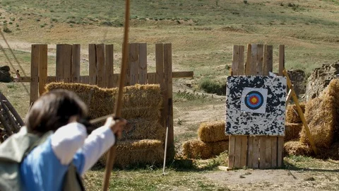 Young woman's arrow missing the target stand Medieval Archery training Video stock 95626302