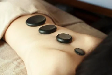Young Woman's Back with Stones of Progressing Size Stock Photos