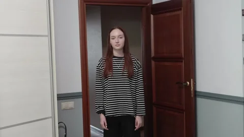 Young Woman's Expression Changes to Serious Vídeo Stock 330044317