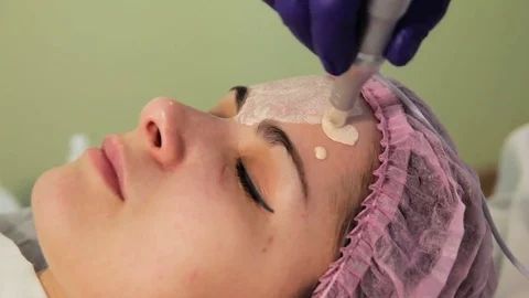 The young woman's face during the procedure closeup. Innovative cosmetic 動画素材 83608468