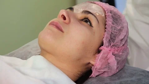 The young woman's face during the procedure closeup. Innovative cosmetic Stock-Footage 83608652