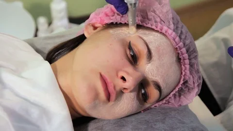 The young woman's face during the procedure closeup. Innovative cosmetic Stock Footage 83621560