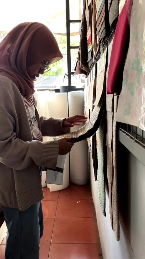 Young Woman's Hand Choosing Fabric Material Pattern For Interior Use-1 Stockbeeldmateriaal 344675522
