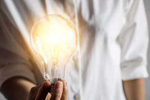 A young woman's hand with a light bulb Conceptual ideas with innovation and i Stock Photos