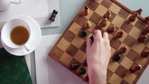 Young woman’s hand moving chess figures on a tea table 스톡 동영상 164147872