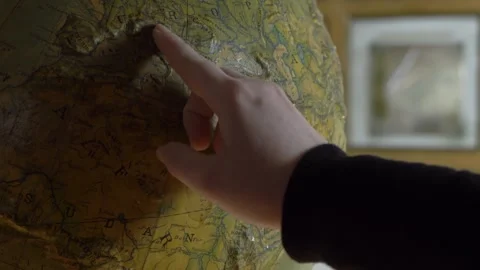 Young woman's Hand Pointing at Specific Spots on a Globe at University Stock Footage 261734929