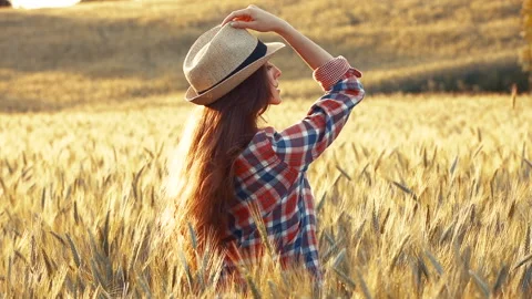 A young woman's hand touching the grass in a wheat field. Young farmer. Stock Footage 132139348