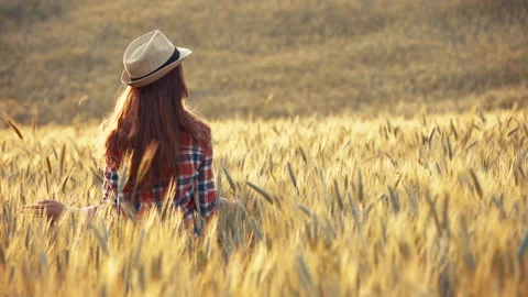 A young woman's hand touching the grass in a wheat field. Young farmer. Stock Footage 132139603