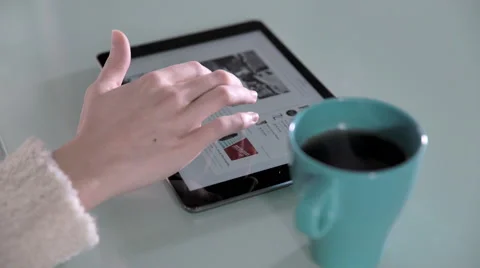 Young woman's hand using tablet during breakfast Video stock 63394795