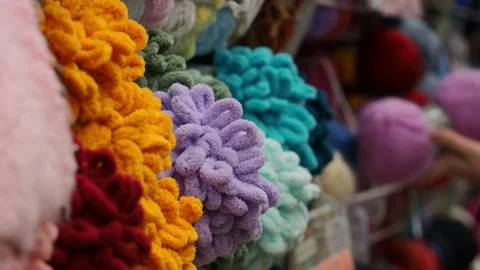 A young woman's hands choose the threads for knitting. Video stock 228999450