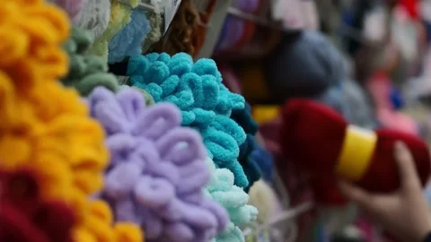 A young woman's hands choose the threads for knitting. Video stock 228999455