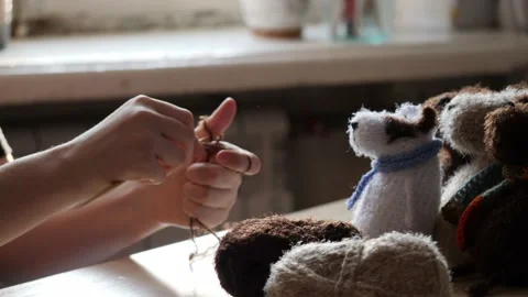 A young woman's hands knit with needles. Video stock 239051132