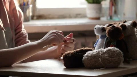 A young woman's hands knit with needles. Video stock 239051133