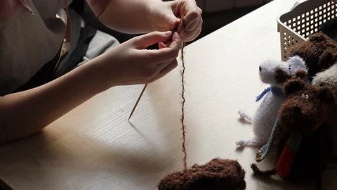 A young woman's hands knit with needles. Video stock 239051143