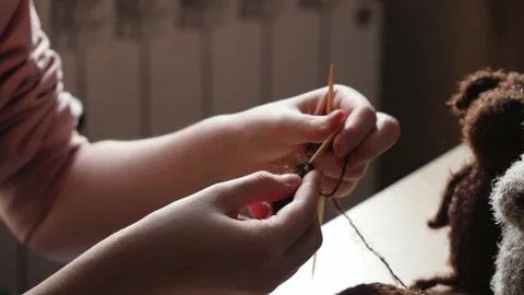 A young woman's hands knit with needles. Video stock 239051147